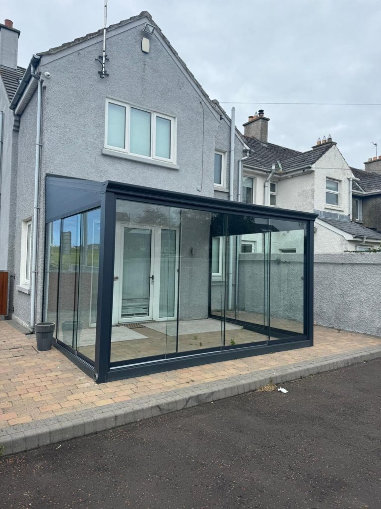 Bosco glass room along the side of a bungalow