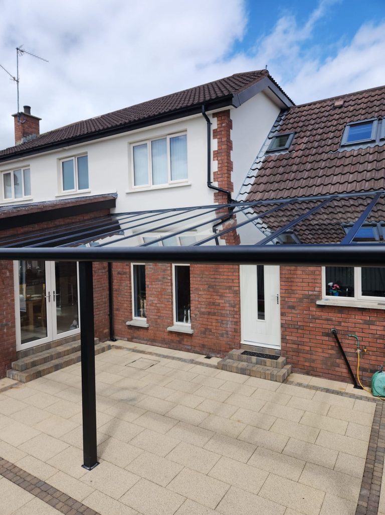 Pigato glass roof over a patio at a brick house