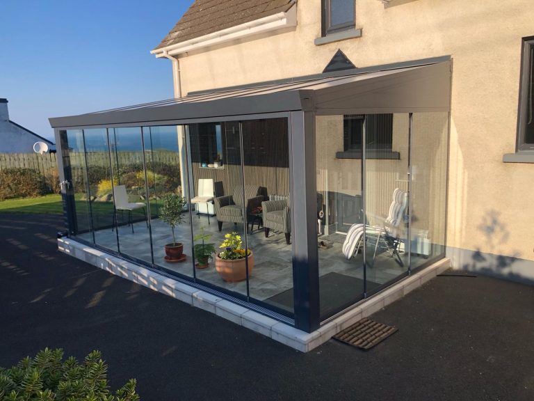 Giallo veranda with glass sides on a paved patio