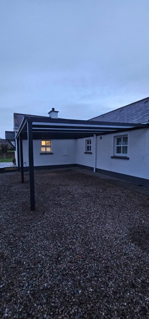 Grey carport at a white house