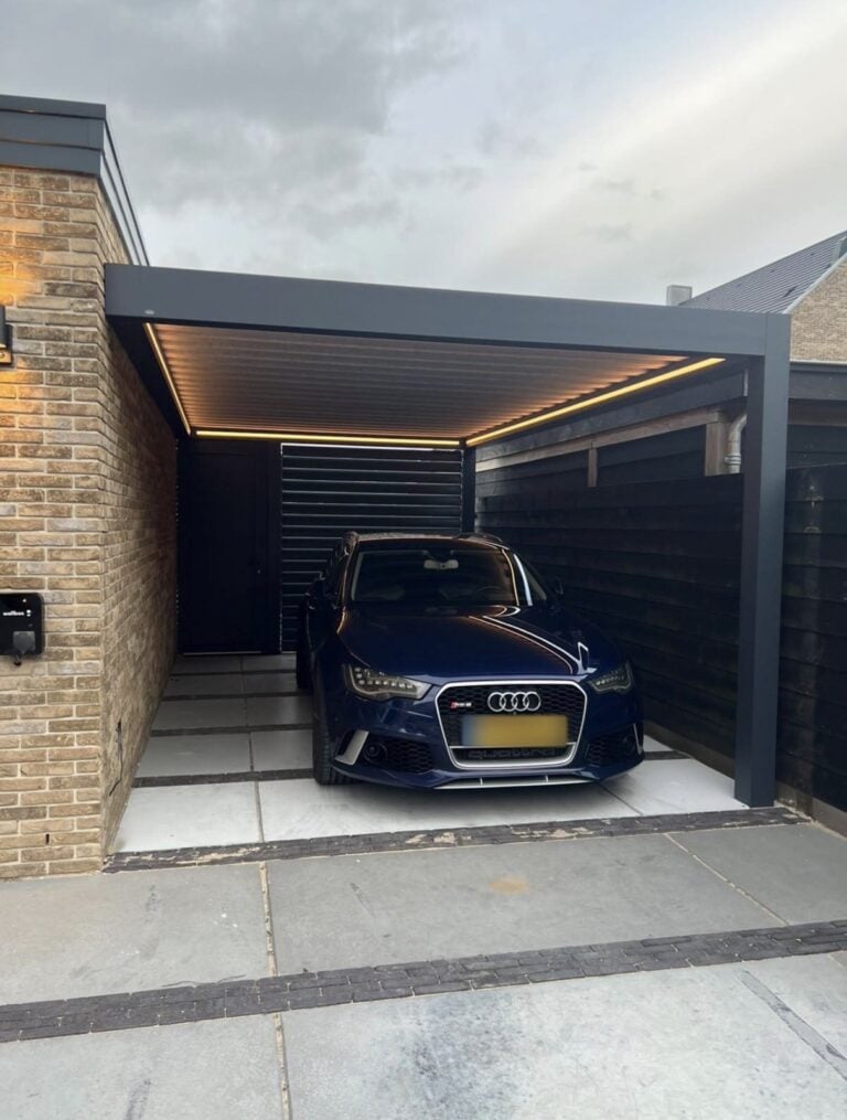 Black aluminium carport with a louvred roof and built-in LED lights over a driveway