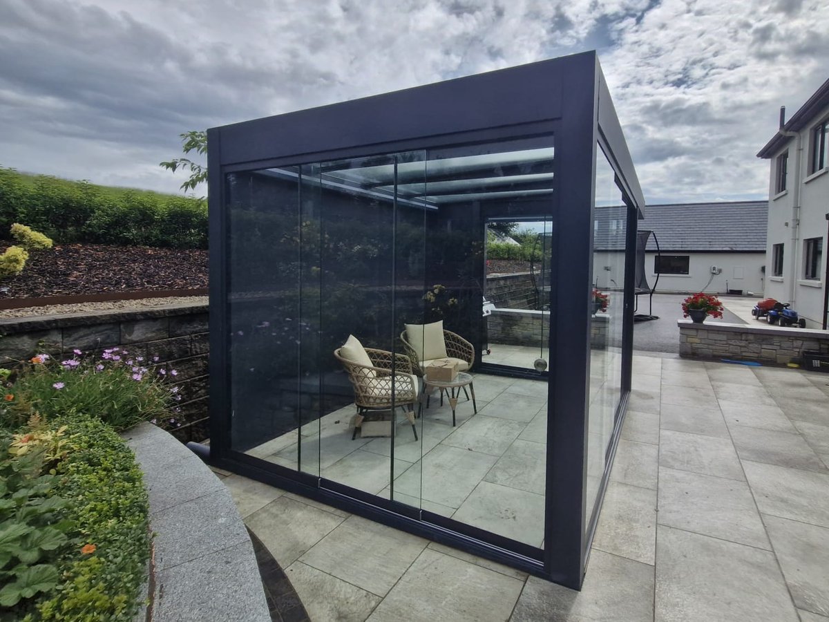 Grey glass pergola closed in with frameless glass sliding doors, Dublin
