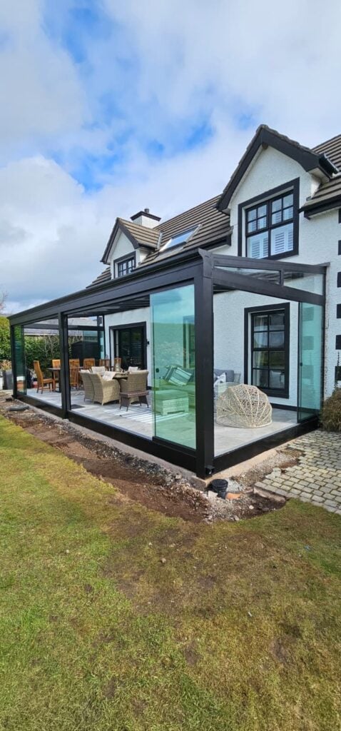 Glass room on a cottage with the sliding doors open