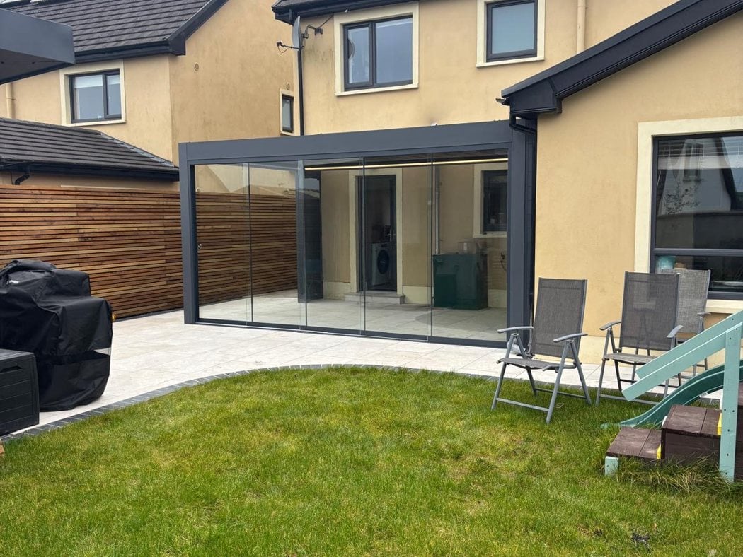 Pergola with an opening aluminium roof and LED lighting, closed in with glass sliding doors