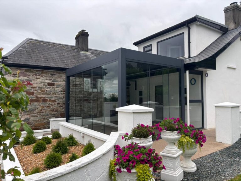 Glass room with a retractable roof fitted by Apex Verandas